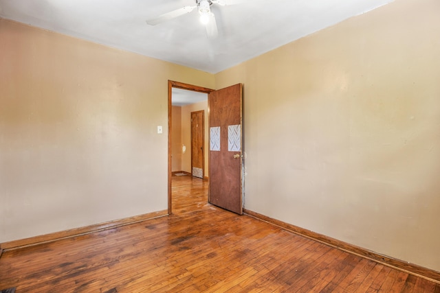 spare room featuring hardwood / wood-style floors and ceiling fan