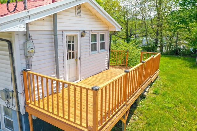 wooden deck featuring a yard