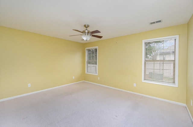 empty room featuring light colored carpet and ceiling fan