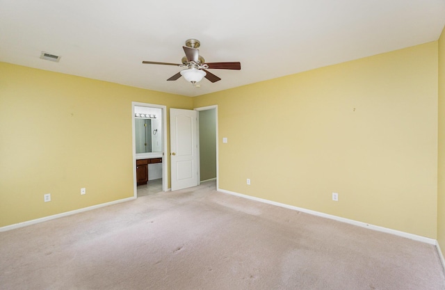 spare room featuring light colored carpet and ceiling fan