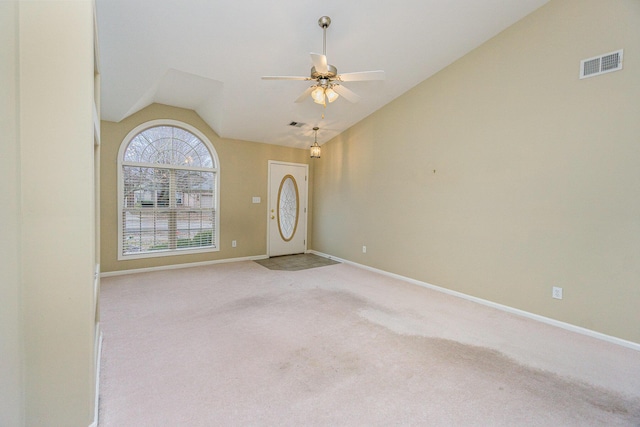 carpeted foyer with vaulted ceiling and ceiling fan