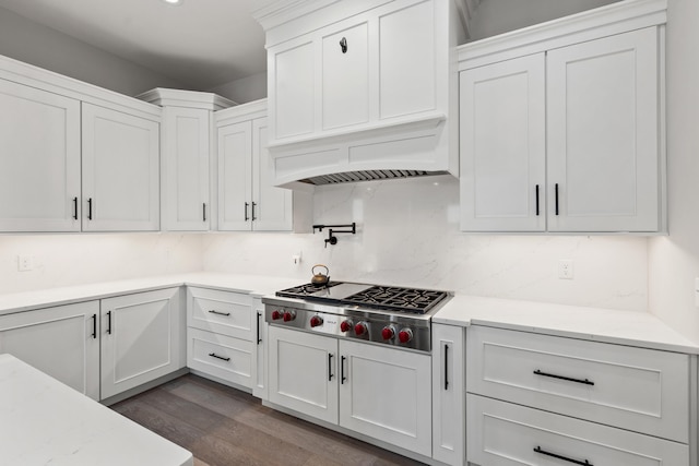 kitchen with white cabinets, dark hardwood / wood-style floors, custom range hood, and stainless steel gas cooktop