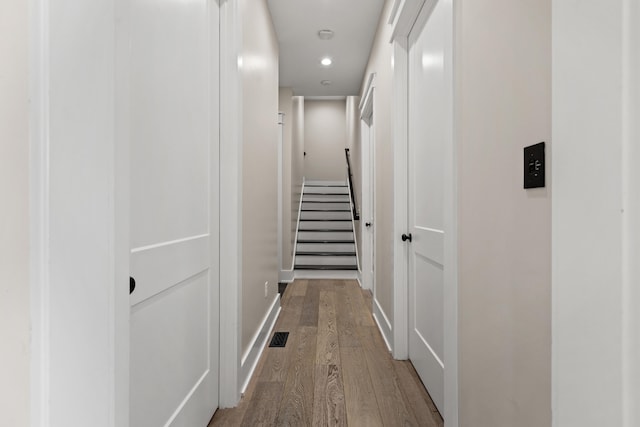 corridor with wood-type flooring