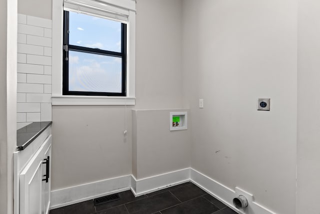 laundry room with hookup for an electric dryer, washer hookup, and dark tile patterned floors