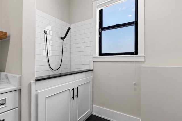 bathroom with vanity and tiled shower