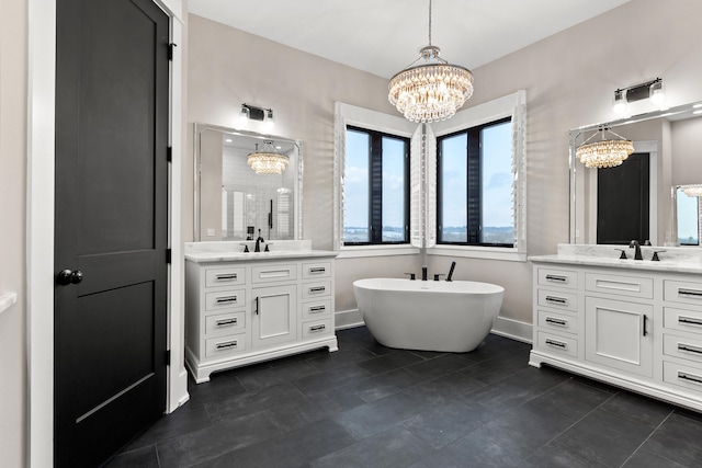 bathroom featuring a bathtub, a notable chandelier, and vanity