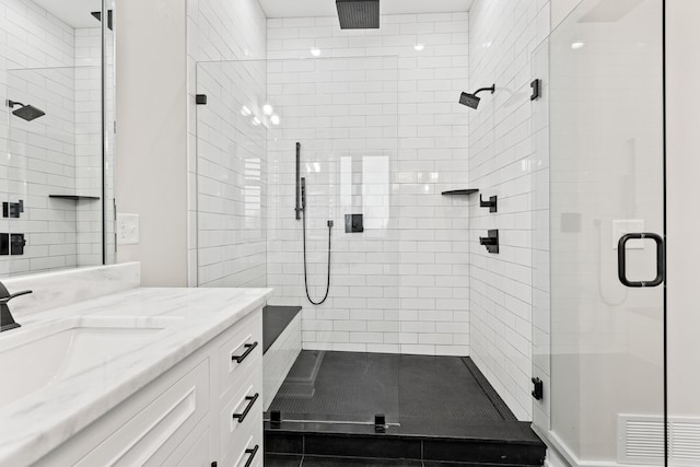 bathroom with walk in shower and vanity