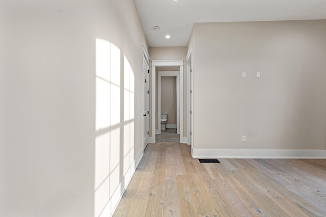 hallway with light hardwood / wood-style flooring