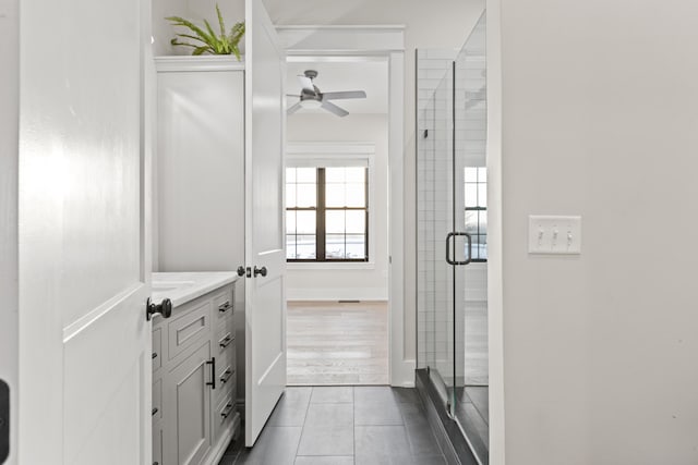 bathroom featuring vanity, ceiling fan, an enclosed shower, and tile patterned flooring