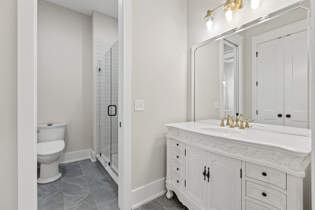 bathroom featuring vanity, toilet, and an enclosed shower