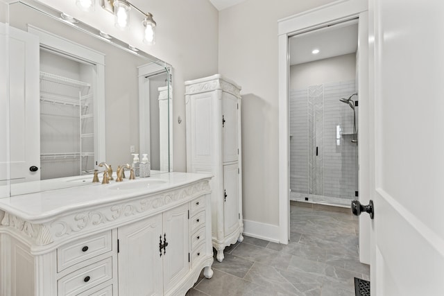 bathroom with vanity and a tile shower