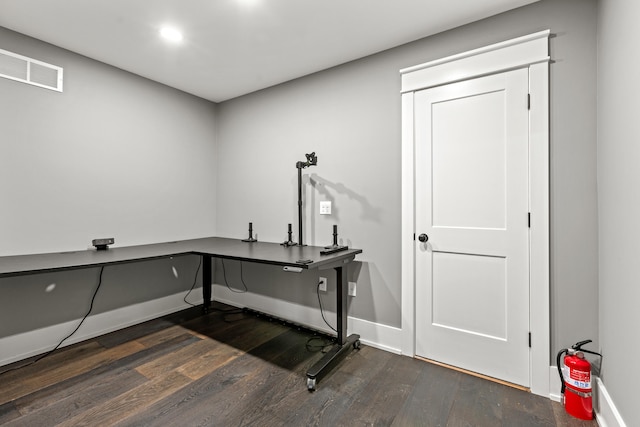 clothes washing area featuring dark hardwood / wood-style floors