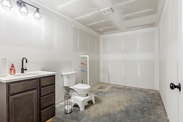 bathroom with vanity, toilet, and concrete floors