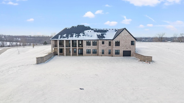 view of snow covered rear of property