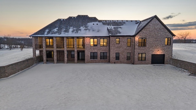 snow covered property featuring a garage