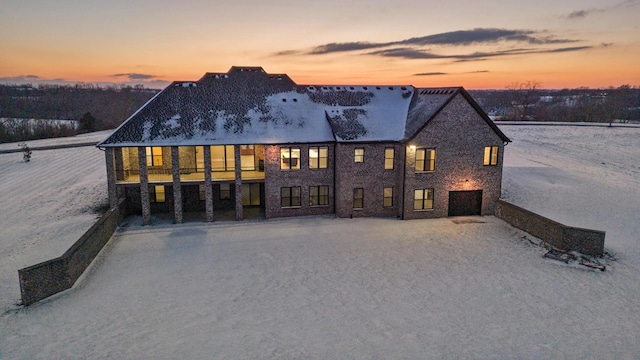 back house at dusk with a garage