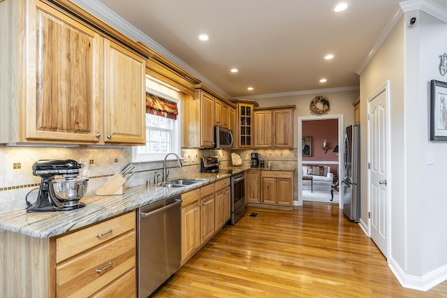 kitchen featuring sink, light stone counters, ornamental molding, stainless steel appliances, and decorative backsplash