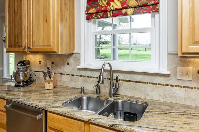 kitchen featuring sink, decorative backsplash, light stone countertops, and dishwasher