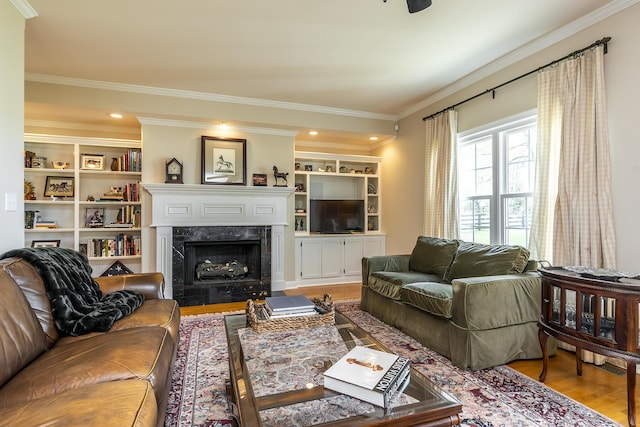 living room featuring hardwood / wood-style flooring, a premium fireplace, and ornamental molding