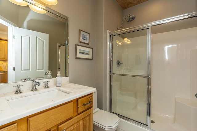 bathroom featuring vanity, toilet, and walk in shower