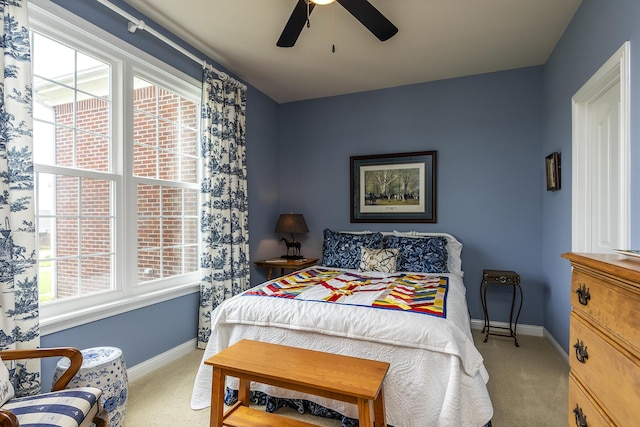 bedroom with light carpet and ceiling fan