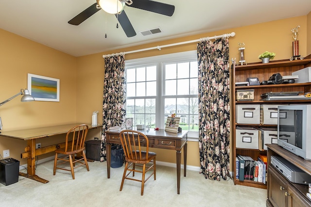 office space featuring light carpet and ceiling fan