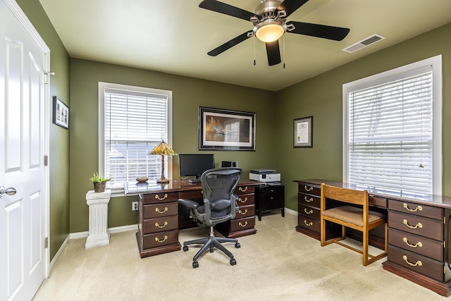 carpeted home office featuring ceiling fan