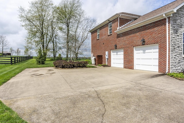 view of property exterior featuring a garage and a yard