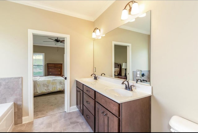 bathroom featuring ornamental molding, vanity, a washtub, ceiling fan, and toilet