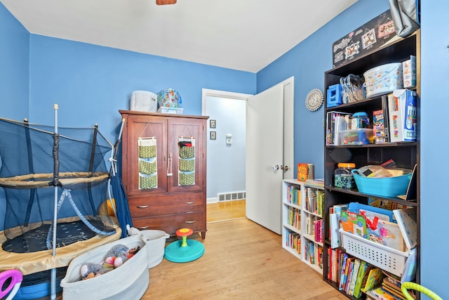 recreation room with light wood-type flooring