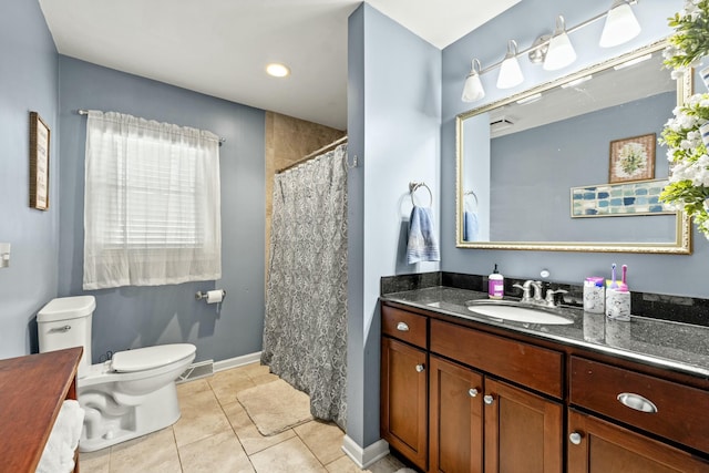 bathroom featuring vanity, tile patterned flooring, and toilet