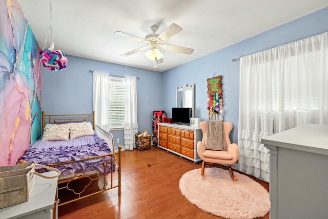 bedroom with wood-type flooring and ceiling fan