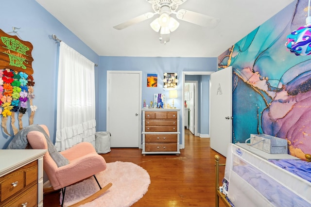 bedroom with dark wood-type flooring and ceiling fan