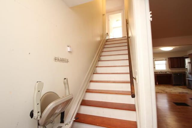 staircase with wood finished floors