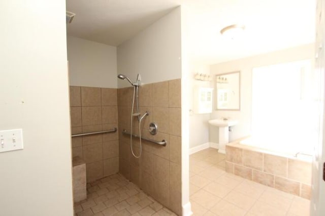 bathroom featuring tiled shower and tile patterned floors