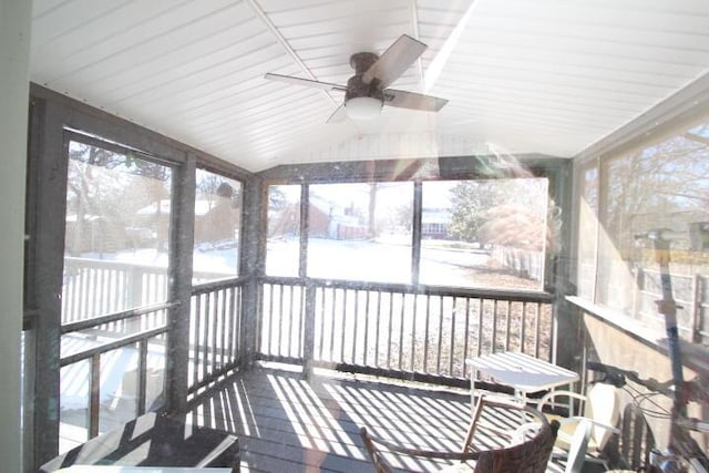 sunroom featuring ceiling fan, vaulted ceiling, and a wealth of natural light