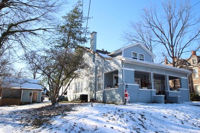 exterior space with a chimney and a porch