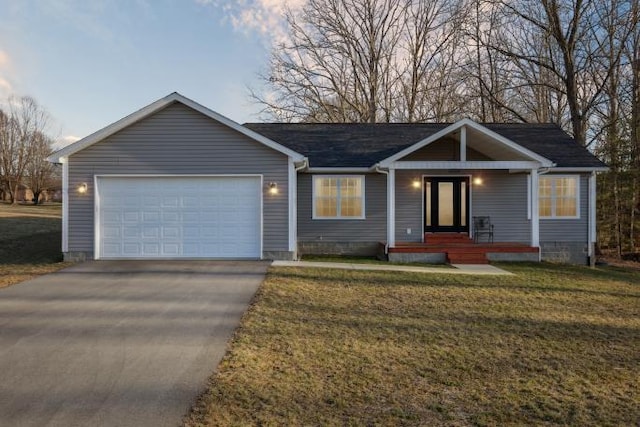 ranch-style house with a front lawn, concrete driveway, and an attached garage