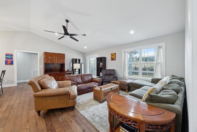 living room with lofted ceiling, light wood-type flooring, a ceiling fan, and recessed lighting