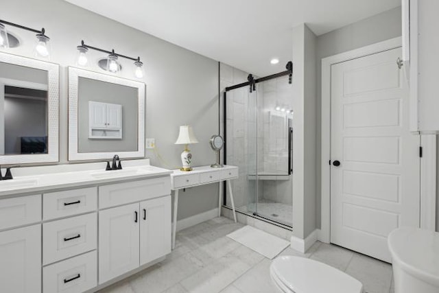 full bath featuring double vanity, a sink, toilet, and a shower stall