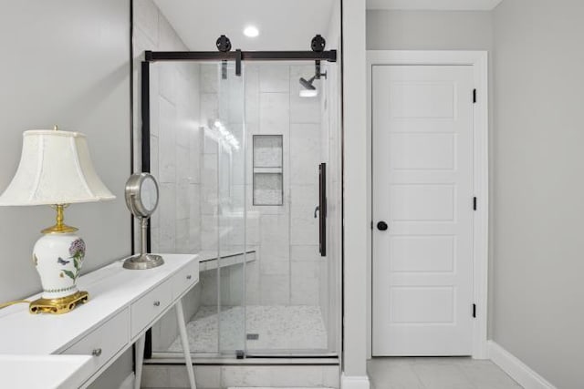 bathroom featuring a stall shower and baseboards