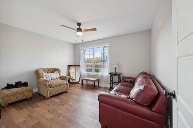 sitting room with ceiling fan and wood finished floors