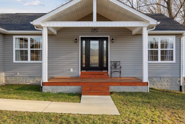 entrance to property featuring roof with shingles