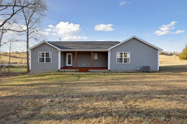 view of front facade with a porch, a front yard, and cooling unit