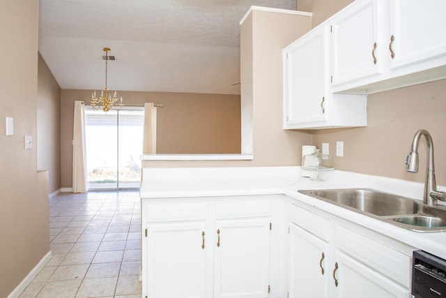 kitchen with light tile patterned floors, sink, dishwasher, white cabinetry, and hanging light fixtures