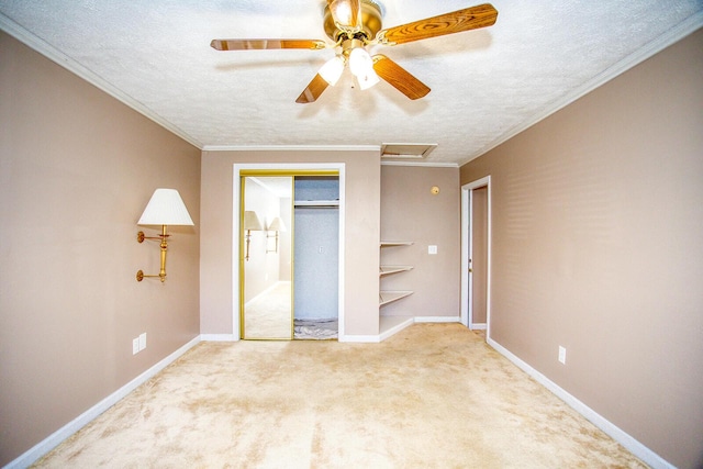 unfurnished bedroom featuring crown molding, ceiling fan, carpet, a textured ceiling, and a closet