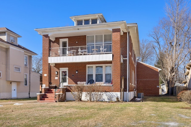 view of front facade featuring a balcony, a front yard, and cooling unit