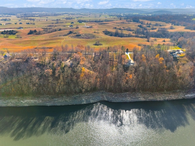 drone / aerial view featuring a water and mountain view