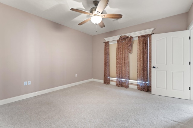 spare room with ceiling fan and light carpet