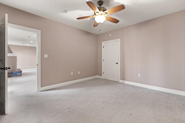 unfurnished room with ceiling fan and light carpet